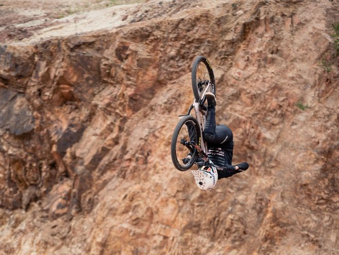 Caroline Buchanan front-flips on her mountain bike